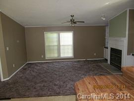 3843 Puetts Chapel Road Dallas, NC 28034 - Photo 2 of 7 a view of an empty room with a fireplace and a window