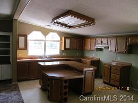 3843 Puetts Chapel Road Dallas, NC 28034 - Photo 4 of 7 a kitchen with a stove a sink and a refrigerator