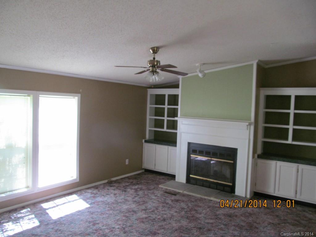 3843 Puetts Chapel Road Dallas, NC 28034 - Photo 5 of 7 a view of a livingroom with a fireplace and window