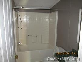 3843 Puetts Chapel Road Dallas, NC 28034 - Photo 6 of 7 a bathroom with a glass shower door