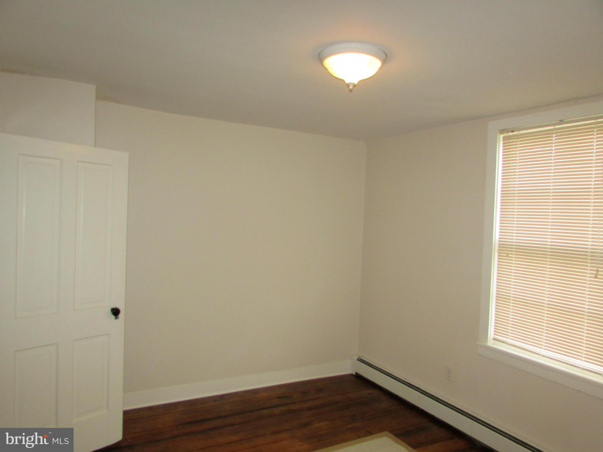 3344 Emory Road North Finksburg, MD 21048 - Photo 26 of 30 a view of an empty room with wooden floor and a window