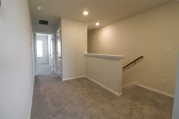an empty room with an entryway and shower