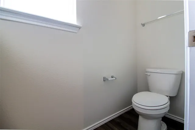 a white toilet sitting next to a small sink
