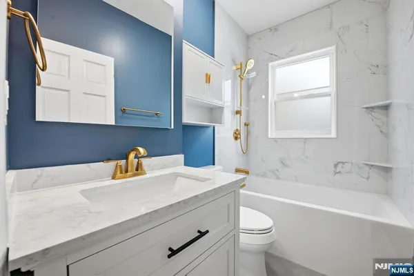 a bathroom with a sink a toilet and a bathtub