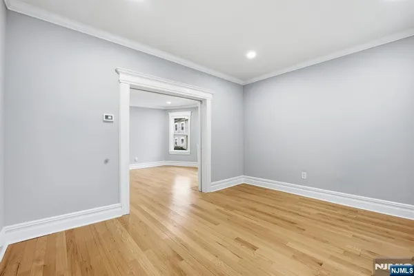 a view of an empty room with wooden floor