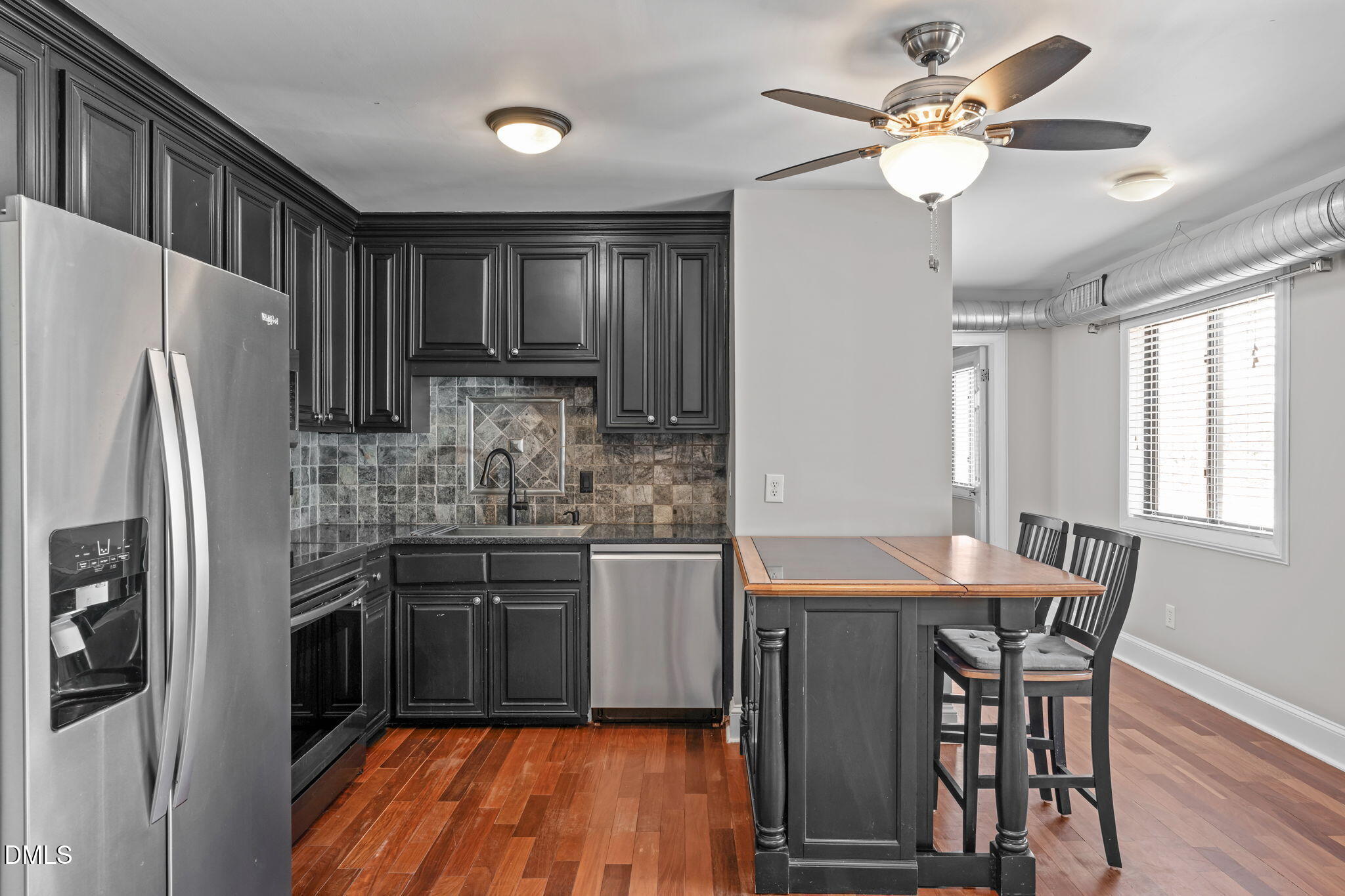 2208 Stafford Avenue Raleigh, NC 27607 - Photo 8 of 30 a kitchen with stainless steel appliances granite countertop a refrigerator a stove a sink dishwasher with a dining table and chairs