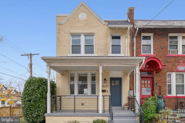 front view of a brick house with a small yard
