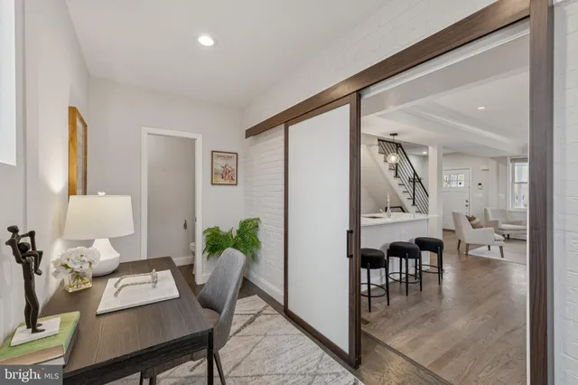 a workspace with furniture and view of kitchen