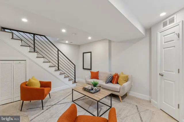 a living room with furniture and a potted plant