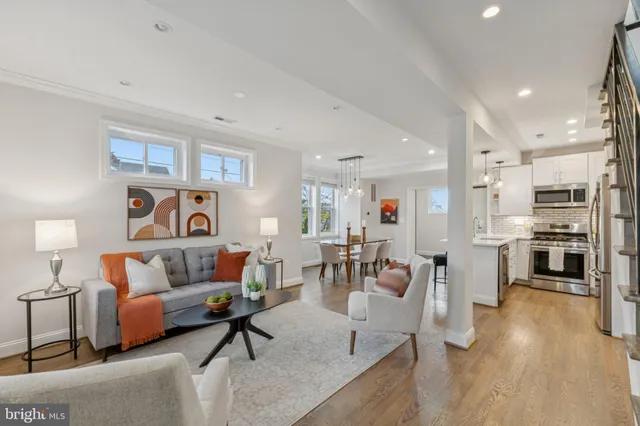 a living room with furniture and kitchen view