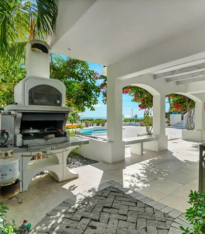 an aerial view of a house with a garden and lake view