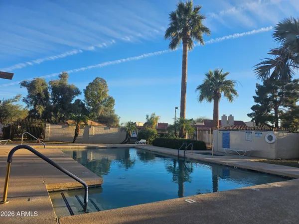 a view of swimming pool with a table and chairs