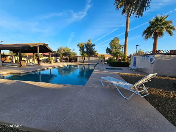 a view of a swimming pool with a lounge chair
