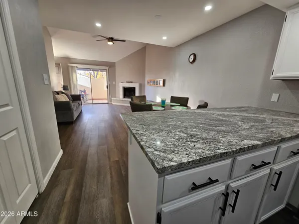 a view of a kitchen with kitchen island a sink wooden floor and wooden floor