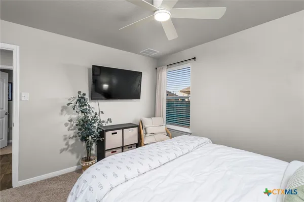 a bathroom with a sink a toilet a mirror a bathtub and shower