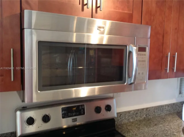 a stove top oven sitting inside of a kitchen
