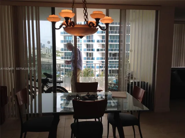 a living room with a flat screen tv and a floor to ceiling window