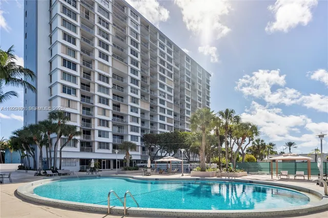 a view of a swimming pool with a yard