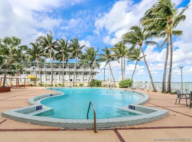 a view of a roof deck with wooden floor and city view
