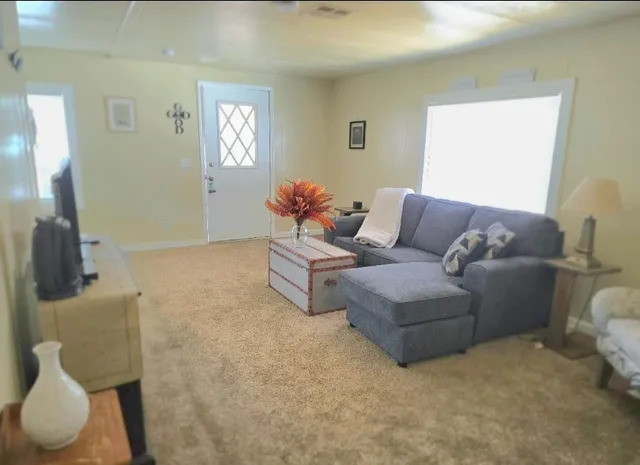 a living room with furniture and a mirror