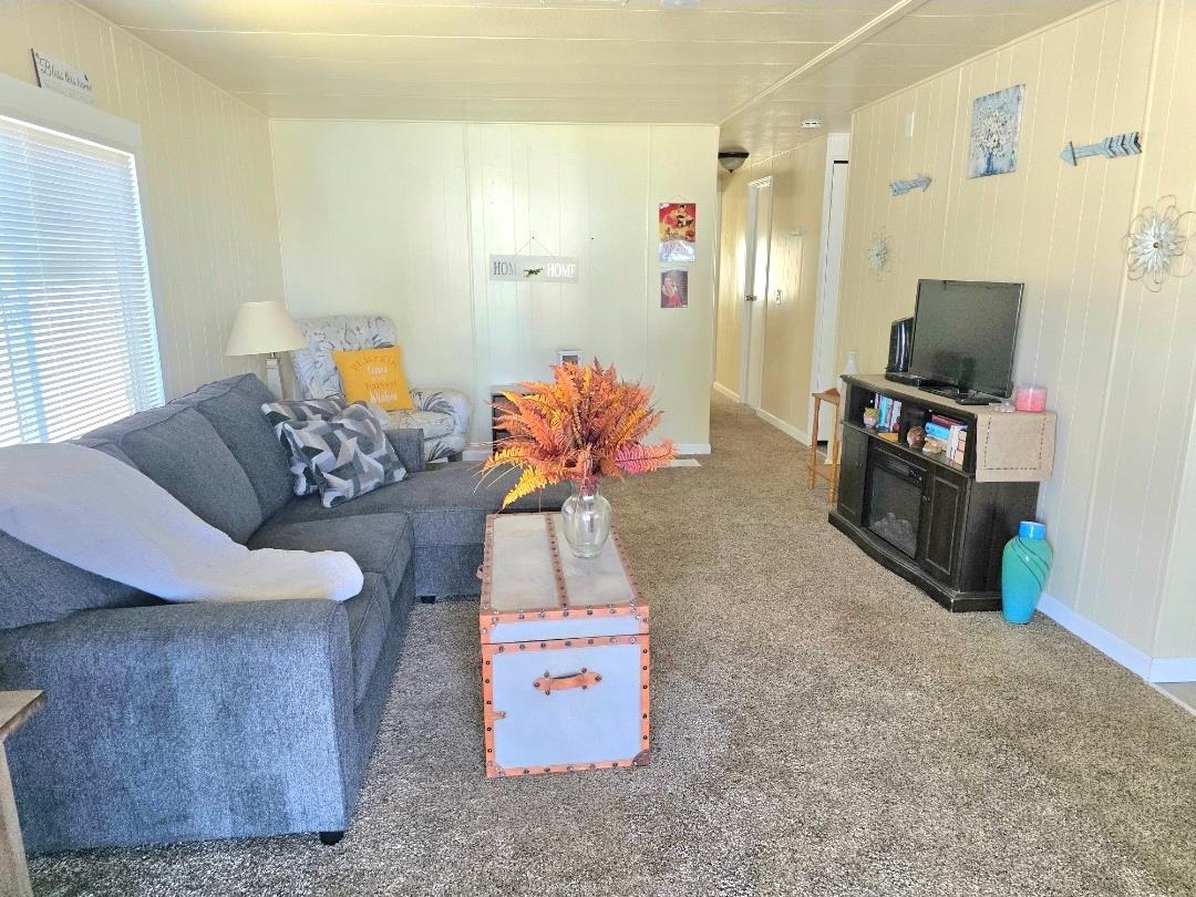 12344-26 Mile Road, Unit 32 Oakdale, CA 95219 - Photo 14 of 22 a living room with furniture and a flat screen tv