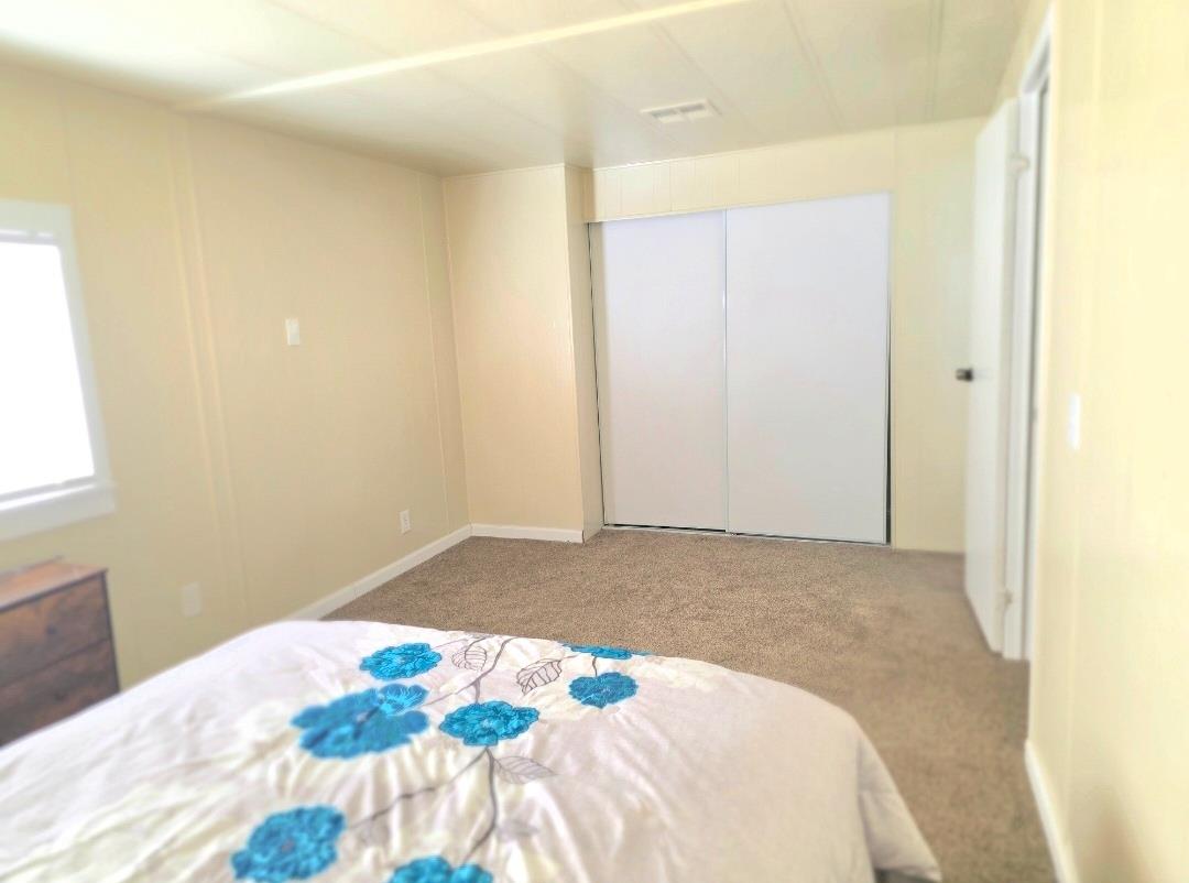 12344-26 Mile Road, Unit 32 Oakdale, CA 95219 - Photo 16 of 22 a bedroom with a bed and a window