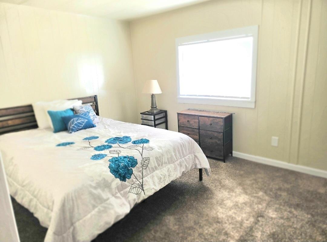 12344-26 Mile Road, Unit 32 Oakdale, CA 95219 - Photo 17 of 22 a bedroom with a bed and a window