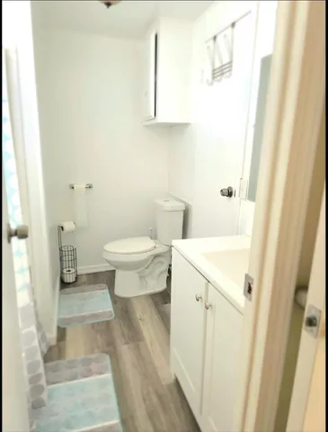 a bathroom with a sink a toilet and a mirror