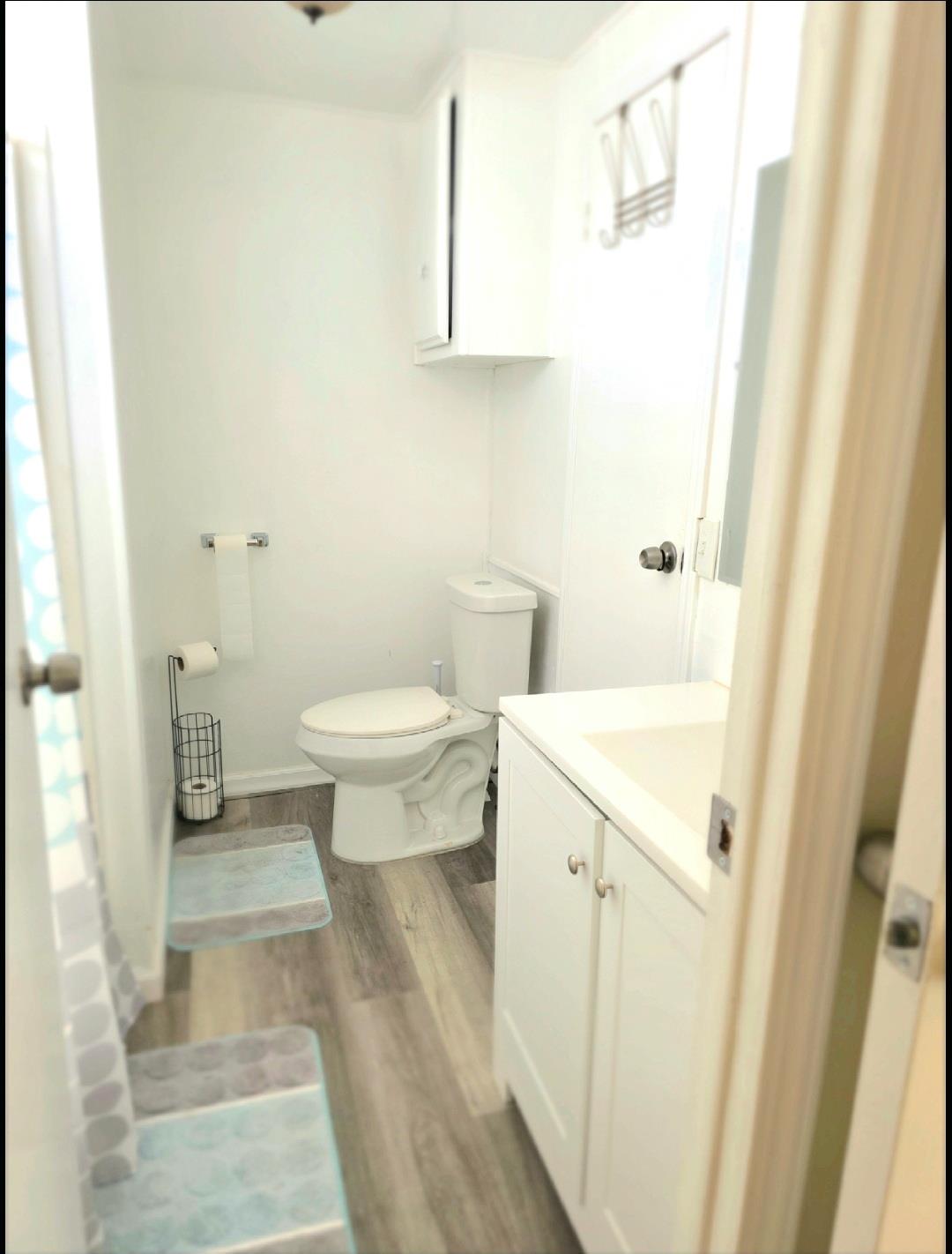 12344-26 Mile Road, Unit 32 Oakdale, CA 95219 - Photo 19 of 22 a bathroom with a sink a toilet and a mirror