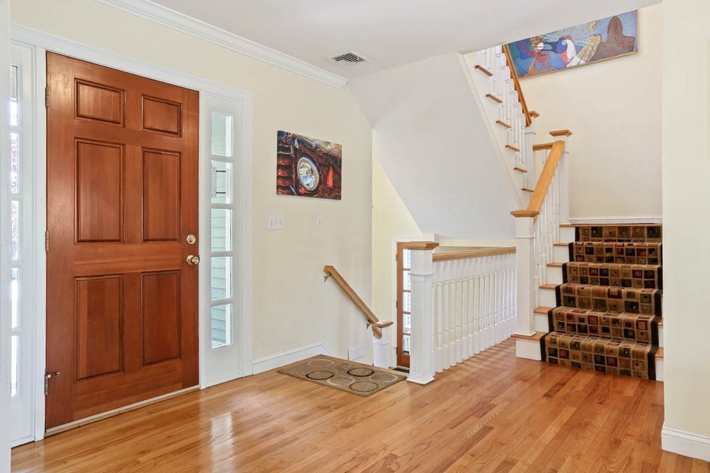 143 Kimball Road Amesbury, MA 01913 - Photo 23 of 30 a view of a livingroom with wooden floor and stairs