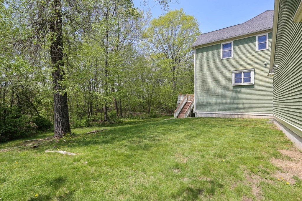 143 Kimball Road Amesbury, MA 01913 - Photo 29 of 30 a backyard of a house with lots of green space