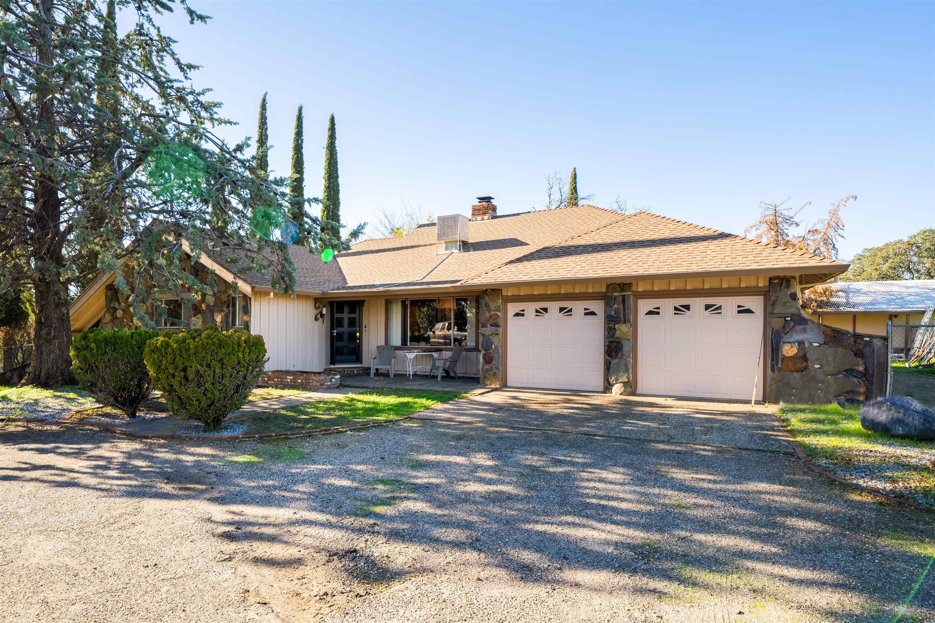 19050 Ridge Road Red Bluff, CA 96080 - Photo 1 of 36 a view of a house with sitting area and large trees