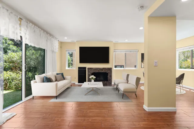 a living room with furniture a fireplace and a flat screen tv