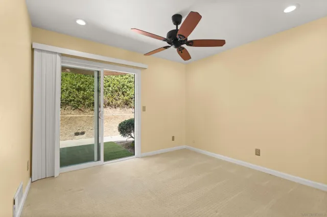 a view of a livingroom with a ceiling fan and window