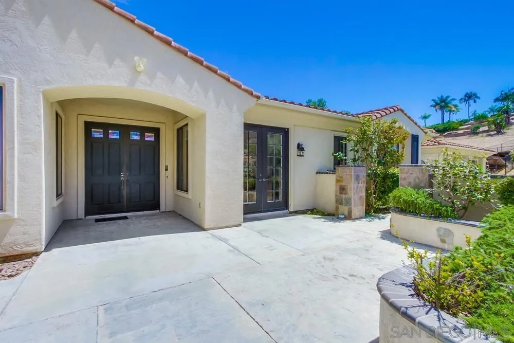 3605-7 Logwood Place Fallbrook, CA 92028 - Photo 12 of 74 a view of a house with potted plants in front of door