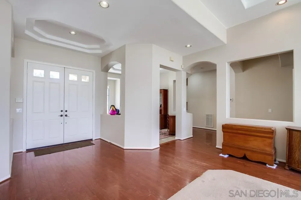 3605-7 Logwood Place Fallbrook, CA 92028 - Photo 18 of 74 a view of an empty room with wooden floor and windows