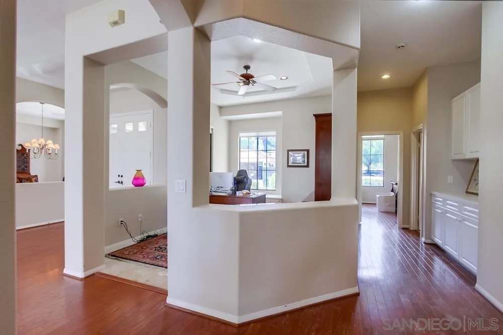 3605-7 Logwood Place Fallbrook, CA 92028 - Photo 20 of 74 a view of a hallway with wooden floor and a living room