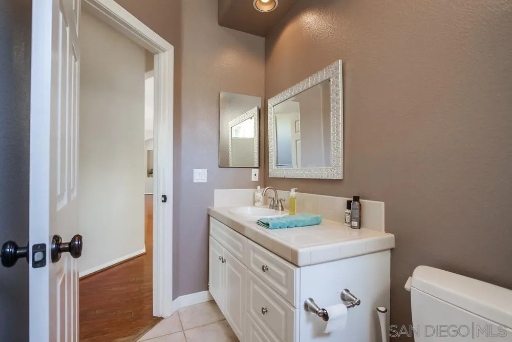3605-7 Logwood Place Fallbrook, CA 92028 - Photo 31 of 74 a bathroom with a double vanity sink mirror and toilet
