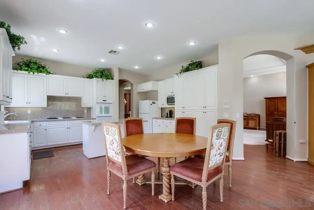 3605-7 Logwood Place Fallbrook, CA 92028 - Photo 38 of 74 a view of a dining room with furniture and wooden floor