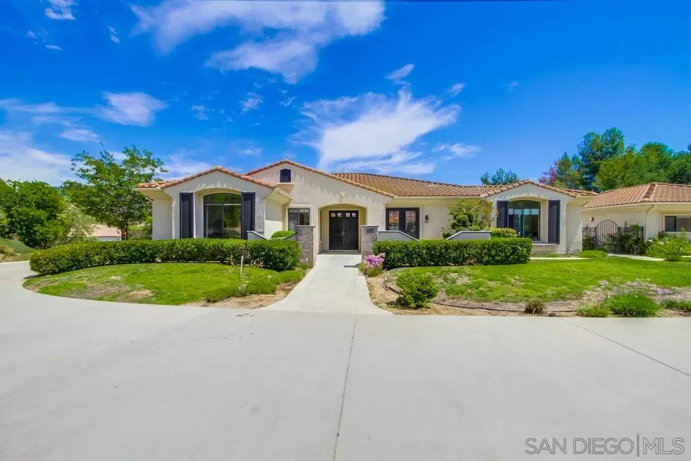 3605-7 Logwood Place Fallbrook, CA 92028 - Photo 4 of 74 a view of a white house with a big yard and potted plants