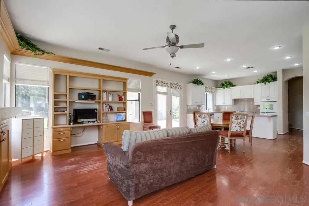 3605-7 Logwood Place Fallbrook, CA 92028 - Photo 43 of 74 a living room with furniture a wooden floor and a kitchen view