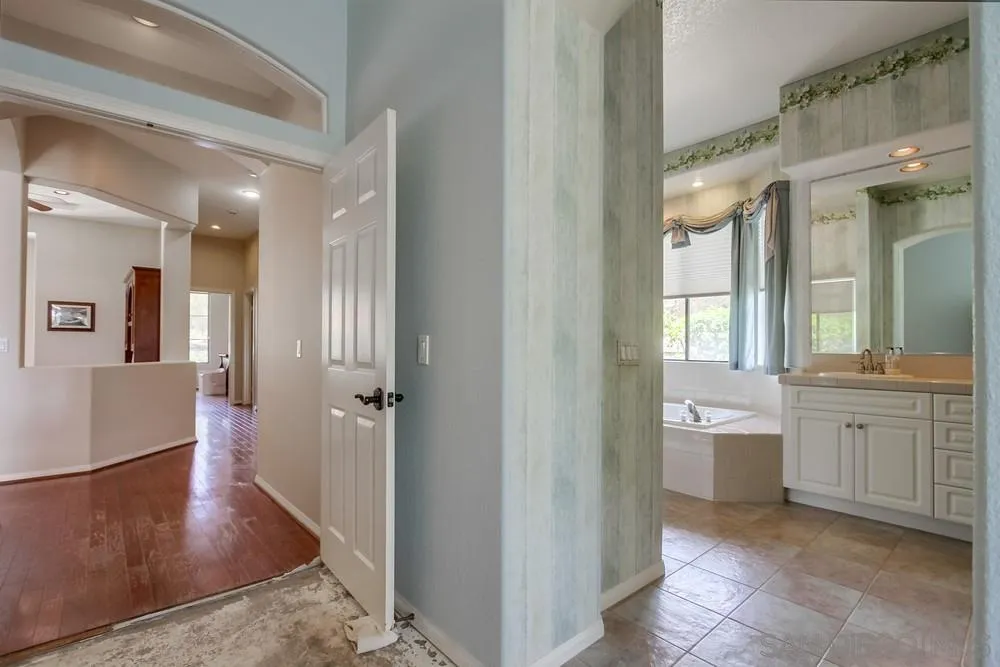 3605-7 Logwood Place Fallbrook, CA 92028 - Photo 50 of 74 a bathroom with a glass door shower a sink and a mirror