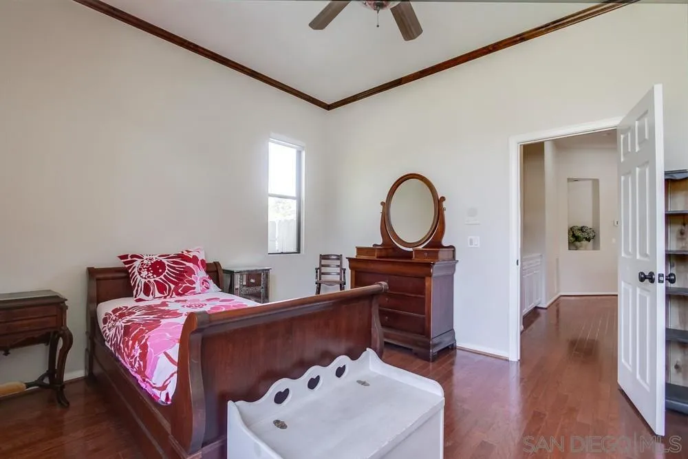 3605-7 Logwood Place Fallbrook, CA 92028 - Photo 59 of 74 a bedroom with a bed and a chandelier