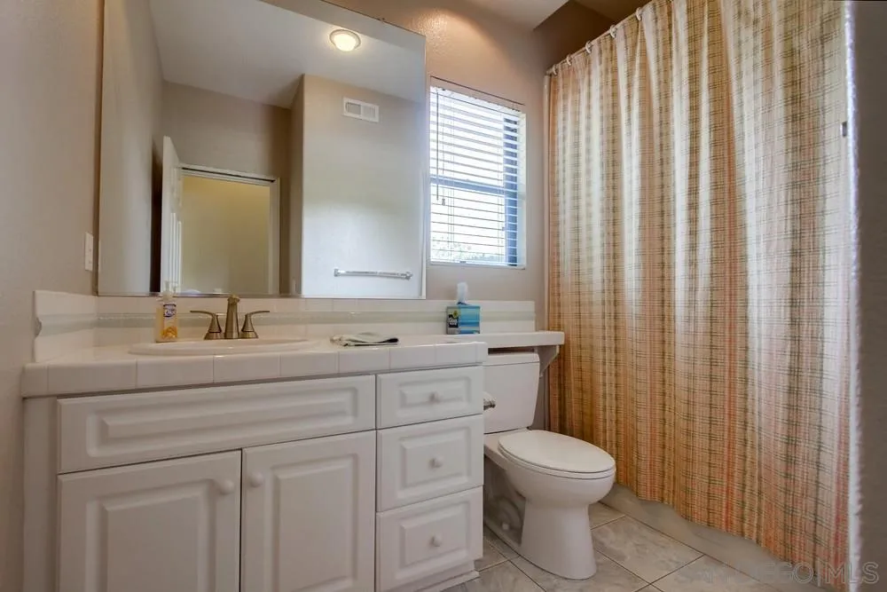 3605-7 Logwood Place Fallbrook, CA 92028 - Photo 61 of 74 a bathroom with a toilet sink and mirror