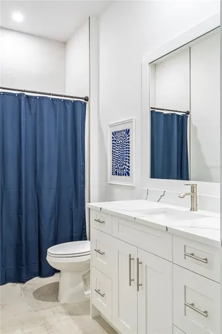 a bathroom with a sink a toilet and a mirror