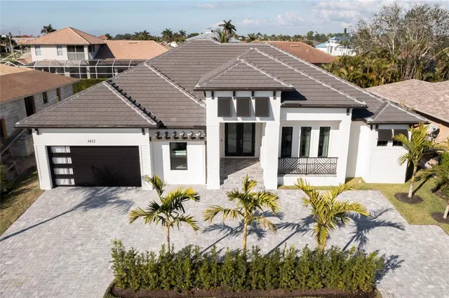 a front view of a house with potted plants