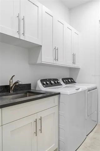 a view white cabinets and sink
