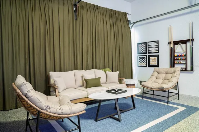 a living room with furniture and a potted plant