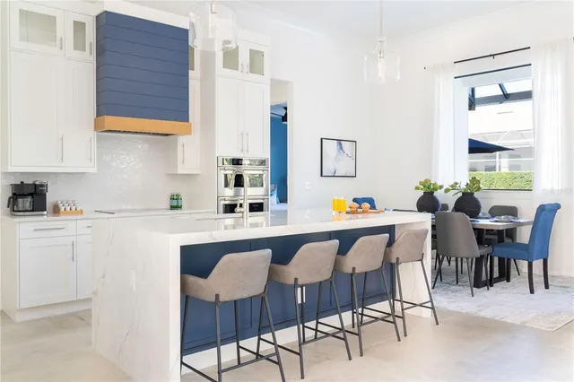 a dining room with furniture a large window and a sink