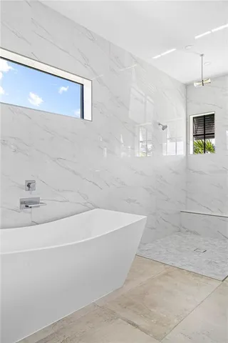 a bathroom with a bathtub and shower